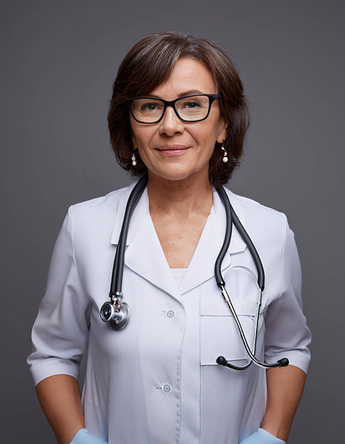 Portrait of a senior female doctor in glasses and uniform, with